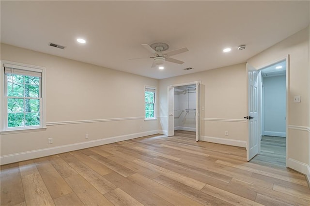 unfurnished bedroom with light wood-type flooring, visible vents, and baseboards