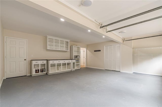 garage with baseboards and recessed lighting