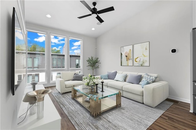 living room with wood-type flooring, ceiling fan, and a healthy amount of sunlight