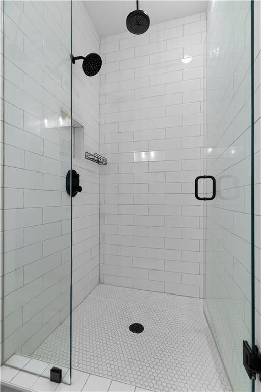 bathroom featuring a shower with shower door