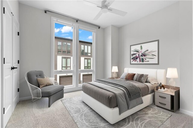 bedroom featuring a closet, light colored carpet, and ceiling fan