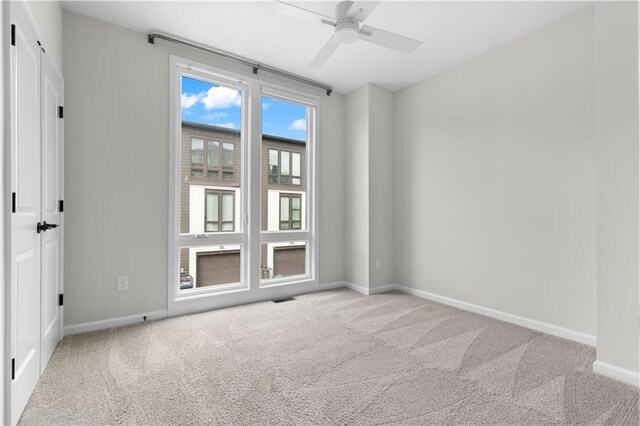 carpeted empty room with ceiling fan