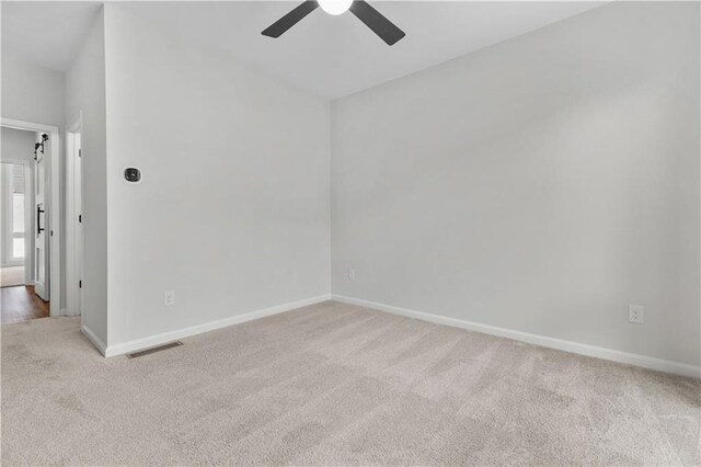 carpeted empty room with ceiling fan