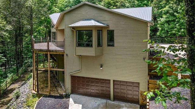 10323 Grassy Mountain Rd, Ellijay, GA 30540 - back of property with an attached garage, driveway, a metal roof, and a balcony
