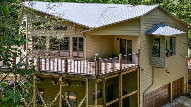 10323 Grassy Mountain Rd, Ellijay, GA 30540 - back of property with a wooden deck, a metal roof, and an attached garage
