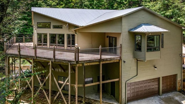 10323 Grassy Mountain Rd, Ellijay, GA 30540 - back of house featuring a deck, an attached garage, a metal roof, and driveway