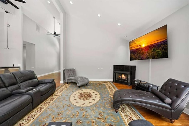 10323 Grassy Mountain Rd, Ellijay, GA 30540 - living room featuring a ceiling fan, wood finished floors, recessed lighting, a tile fireplace, and high vaulted ceiling