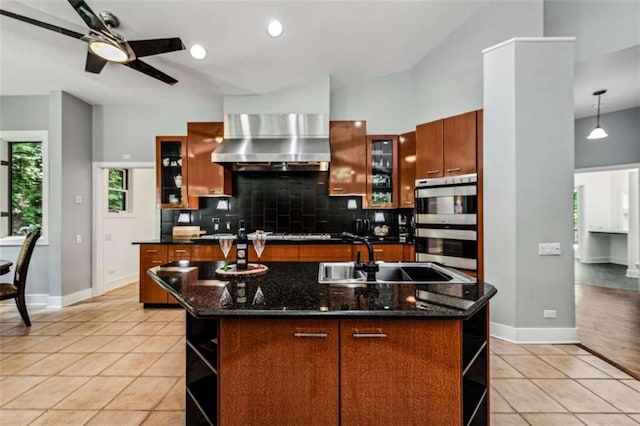 10323 Grassy Mountain Rd, Ellijay, GA 30540 - kitchen with open shelves, wall chimney exhaust hood, a center island with sink, stainless steel double oven, and backsplash