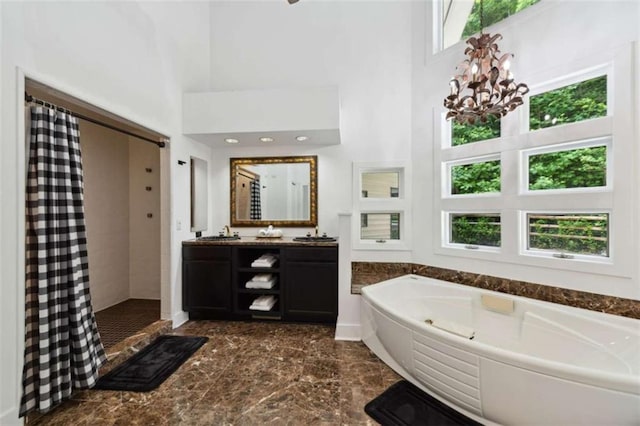 10323 Grassy Mountain Rd, Ellijay, GA 30540 - bathroom featuring a tile shower, a high ceiling, a bath, double vanity, and marble finish floors