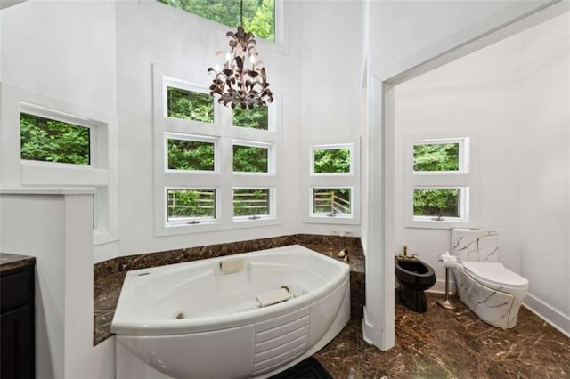 10323 Grassy Mountain Rd, Ellijay, GA 30540 - full bathroom featuring marble tiled flooring, a whirlpool tub, a chandelier, vanity, and a high ceiling