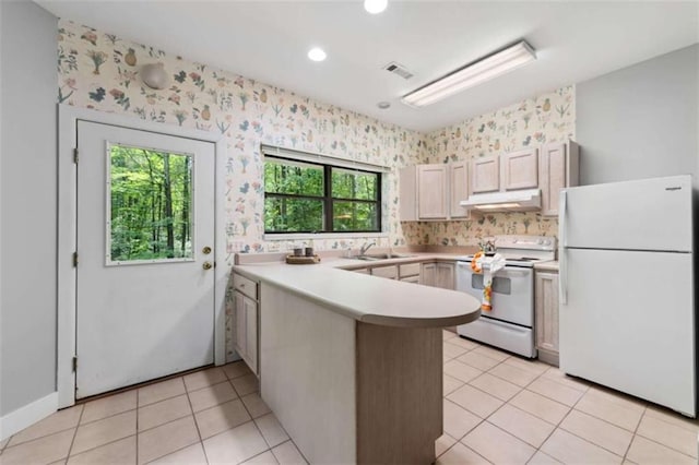 10323 Grassy Mountain Rd, Ellijay, GA 30540 - kitchen featuring white appliances, under cabinet range hood, a peninsula, light countertops, and light tile patterned flooring
