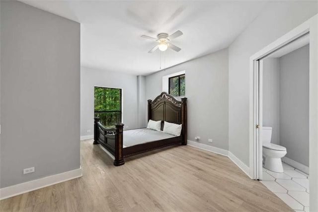 10323 Grassy Mountain Rd, Ellijay, GA 30540 - unfurnished bedroom featuring light wood-style flooring, connected bathroom, and a ceiling fan