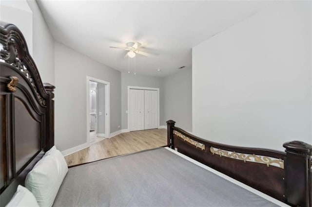 10323 Grassy Mountain Rd, Ellijay, GA 30540 - bedroom featuring wood finished floors, ensuite bathroom, a closet, and ceiling fan