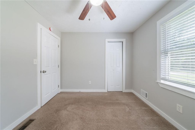 10150 Puckett St, Covington, GA 30014 - unfurnished bedroom with carpet, a closet, and a ceiling fan