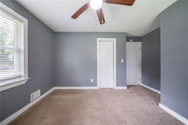 10150 Puckett St, Covington, GA 30014 - unfurnished bedroom with carpet floors, a closet, and a ceiling fan