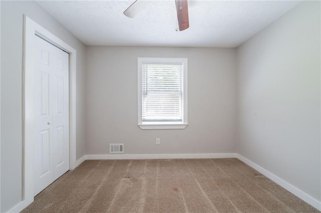10150 Puckett St, Covington, GA 30014 - unfurnished bedroom featuring carpet floors, a closet, a textured ceiling, and ceiling fan