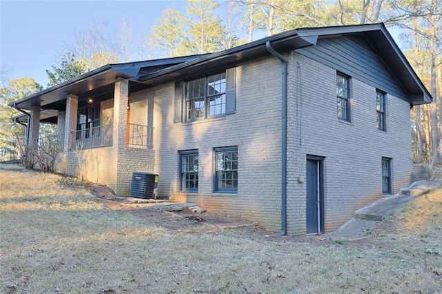 view of home's exterior with central air condition unit and brick siding