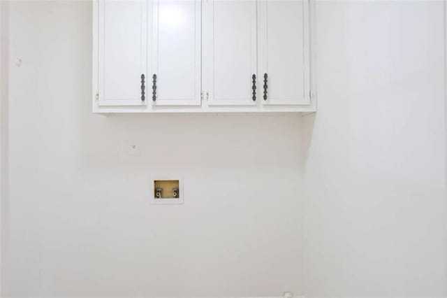 washroom with washer hookup and cabinet space