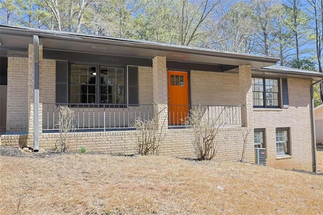 view of front of house featuring a porch and brick siding