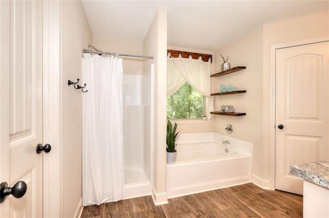 340 Thoroughbred Trl, Monroe, GA 30655 - full bath featuring wood finished floors, a bath, a shower with shower curtain, and baseboards