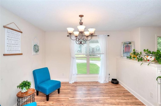 340 Thoroughbred Trl, Monroe, GA 30655 - unfurnished room with a chandelier, wood finished floors, baseboards, and a textured ceiling