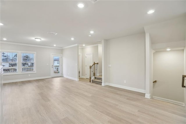 unfurnished living room featuring ornamental molding and light hardwood / wood-style floors