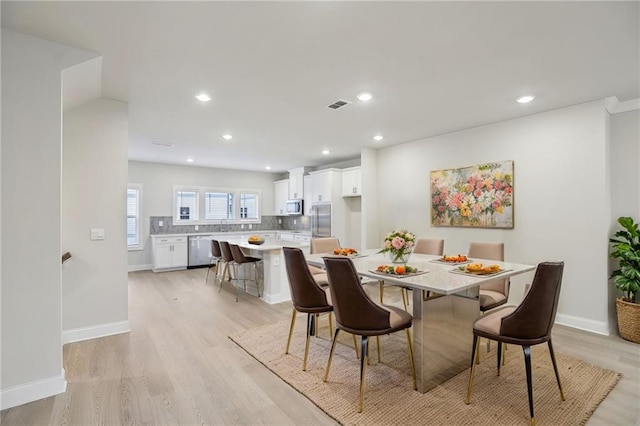 dining space featuring light hardwood / wood-style floors