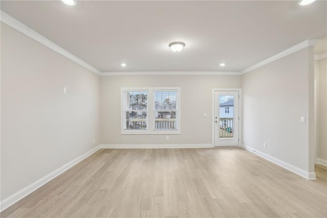 spare room with ornamental molding and light wood-type flooring