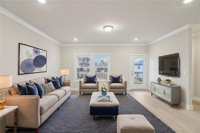 living room with ornamental molding and light wood-type flooring