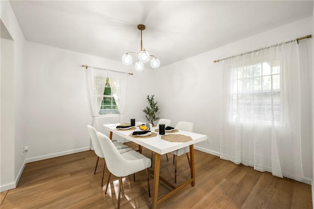 dining room featuring hardwood / wood-style floors and a notable chandelier