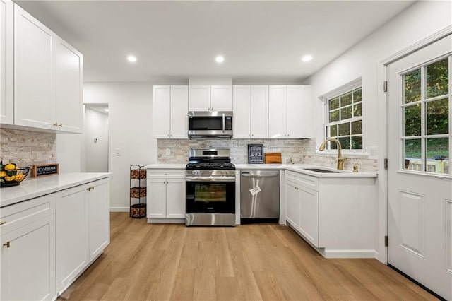 kitchen featuring sink, white cabinetry, and stainless steel appliances