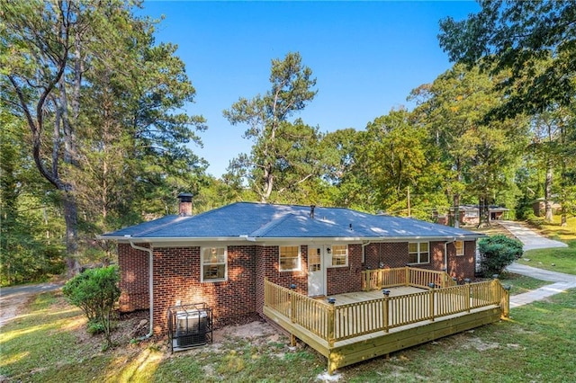 back of property featuring a wooden deck