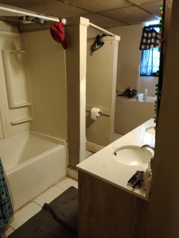 1005 Ashby Ter, Atlanta, GA 30314 - bathroom featuring tile patterned floors, shower / bathtub combination with curtain, a drop ceiling, and vanity