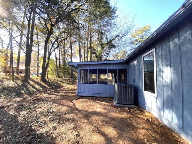 view of home's exterior featuring a sunroom and central air condition unit