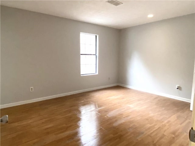 spare room with wood-type flooring