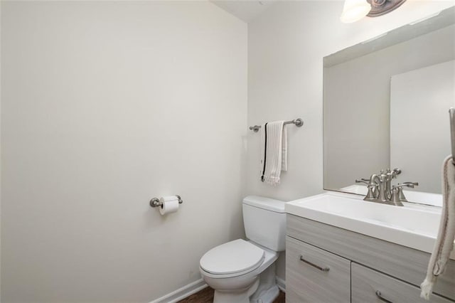 bathroom with toilet and vanity