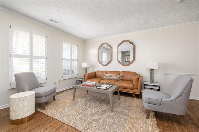 living room with a textured ceiling, dark hardwood / wood-style floors, and ornamental molding