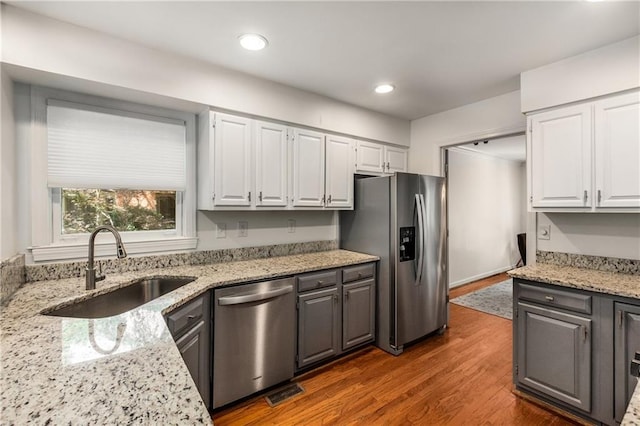 1341 Sheffield Glen Way NE, Atlanta, GA 30329 - kitchen featuring appliances with stainless steel finishes, a sink, white cabinets, wood finished floors, and recessed lighting