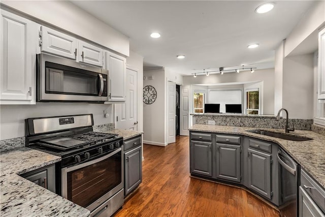 1341 Sheffield Glen Way NE, Atlanta, GA 30329 - kitchen with stainless steel appliances, a sink, gray cabinets, white cabinets, and light stone countertops