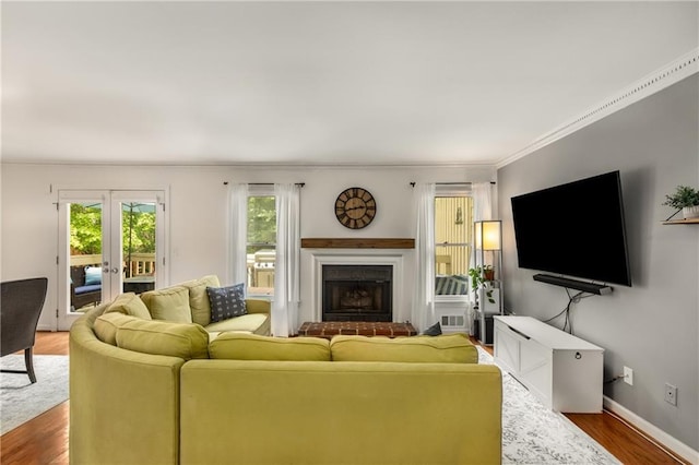 1341 Sheffield Glen Way NE, Atlanta, GA 30329 - living area with crown molding, french doors, wood finished floors, a brick fireplace, and baseboards