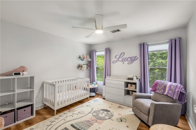 1341 Sheffield Glen Way NE, Atlanta, GA 30329 - bedroom featuring a crib, wood finished floors, and ceiling fan