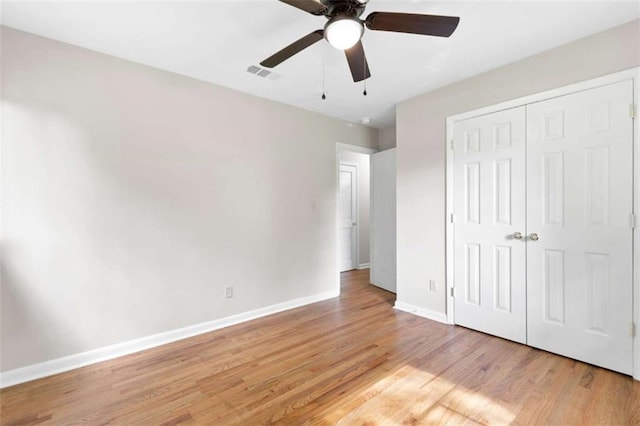 6671 Gano Dr, Riverdale, GA 30274 - unfurnished bedroom featuring light wood-style floors, a closet, and a ceiling fan