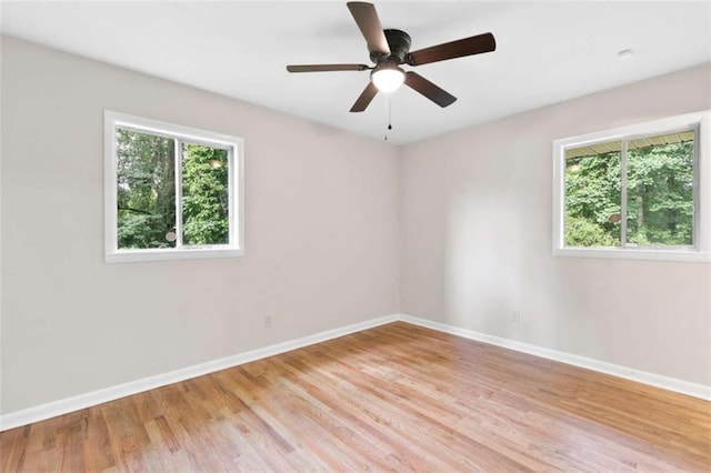 6671 Gano Dr, Riverdale, GA 30274 - empty room with healthy amount of natural light, light wood-type flooring, and a ceiling fan