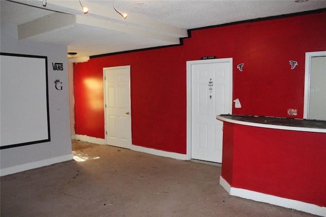 interior space featuring indoor bar and a textured ceiling