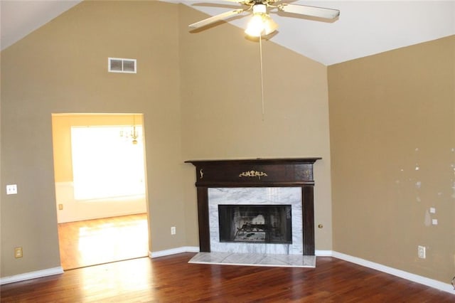 unfurnished living room with ceiling fan, a fireplace, high vaulted ceiling, and wood-type flooring