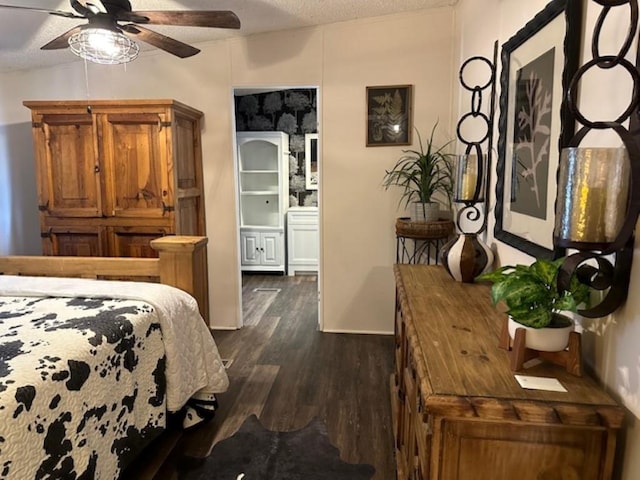 bedroom featuring dark wood-style flooring and a textured ceiling