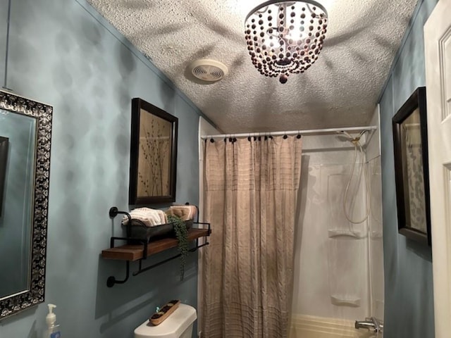 bathroom featuring visible vents, a textured ceiling, and shower / tub combo with curtain