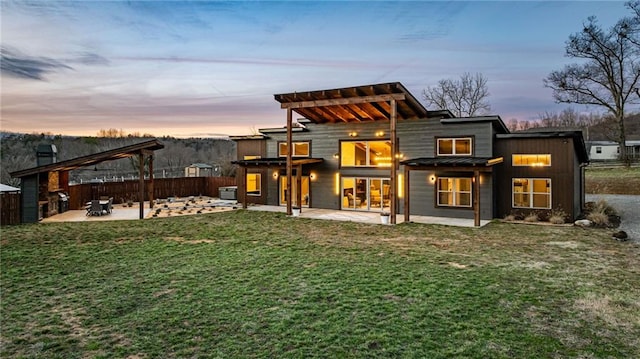 rear view of property with metal roof, a standing seam roof, fence, a yard, and a patio area