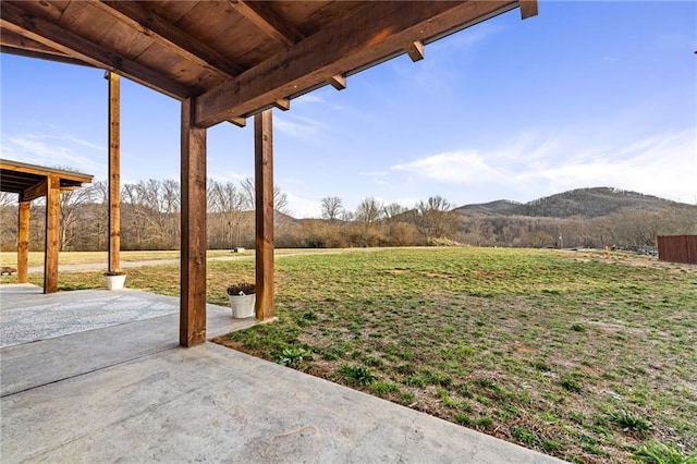 view of yard featuring a mountain view and a patio