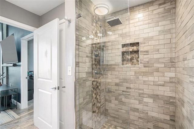 bathroom featuring tiled shower and hardwood / wood-style floors